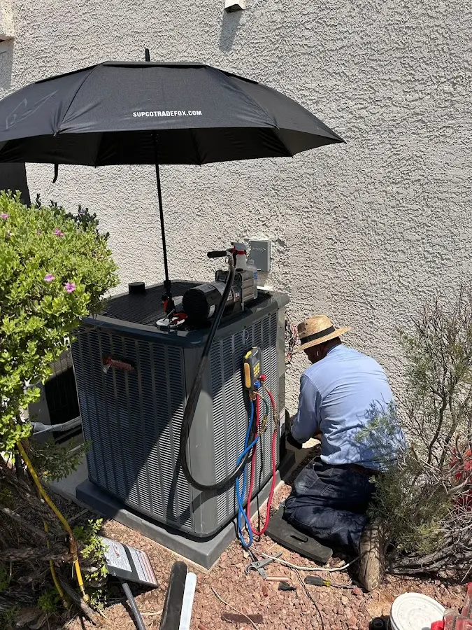 HVAC technician performing outdoor AC maintenance in Interlaken
